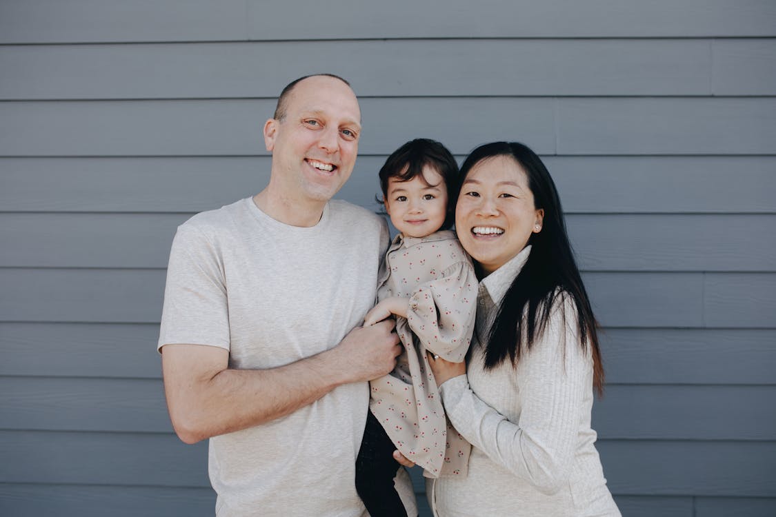 Free Portrait Of A Loving Couple With Their Child Stock Photo