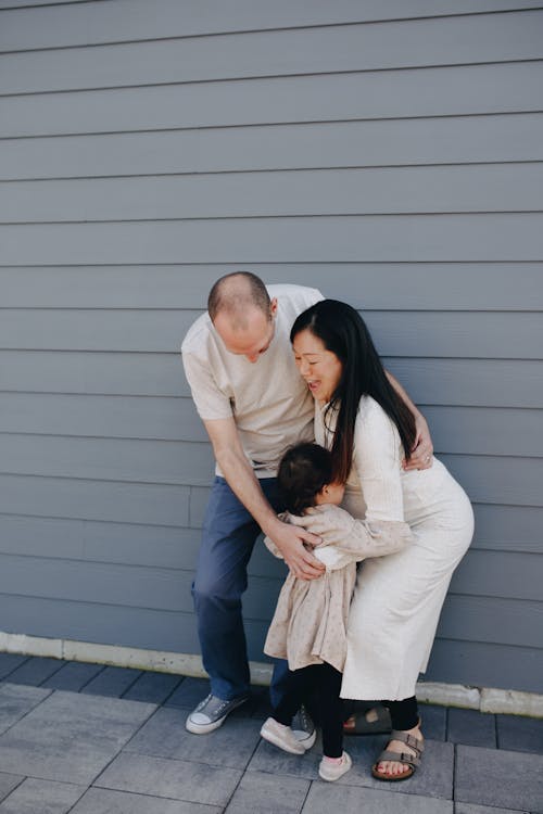 Free Mother And Father Holding Their Child Stock Photo