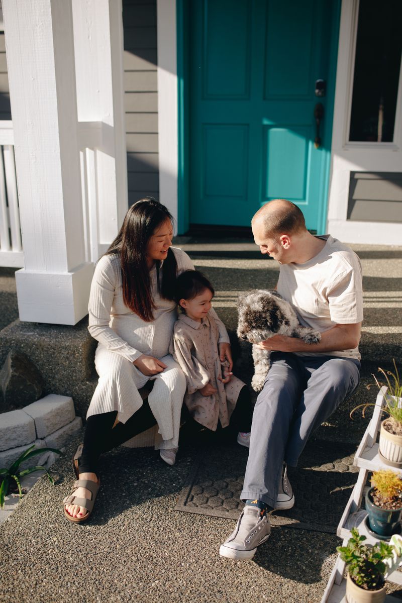 Family on the steps of their new PartNerd-built home