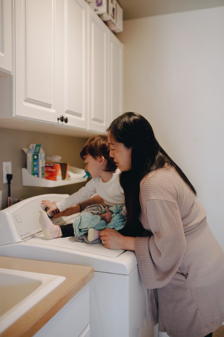 Mother And Child In The Laundry Room