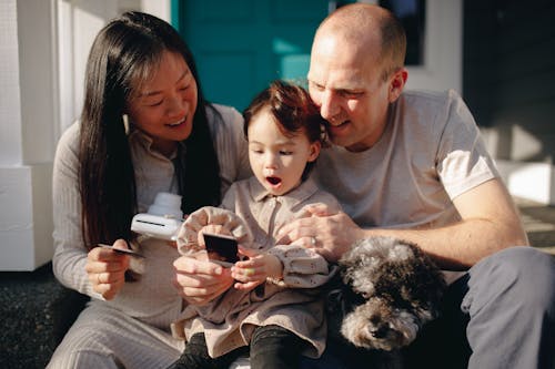 Happy Family Looking At An Instant Photo
