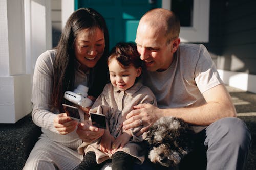 Free Family Looking At Their Instant Photos Stock Photo