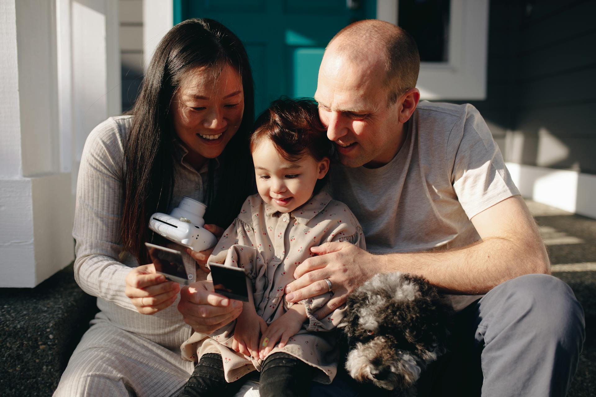 Family Looking At Their Instant Photos