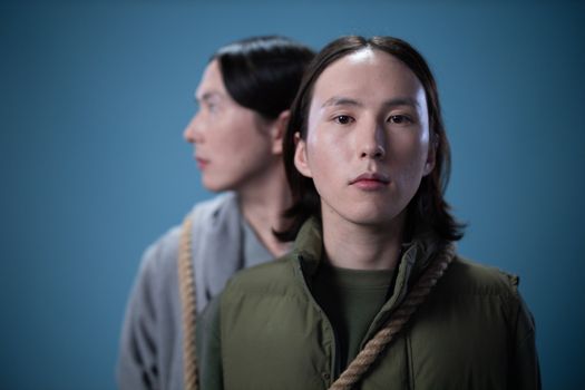 Two people in a conceptual portrait with ropes, captured with selective focus.