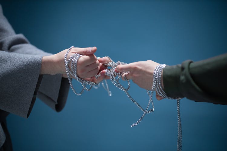 Hands Pulling The Silver Chain