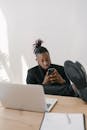 Man using Phone with his Legs Up on the Table