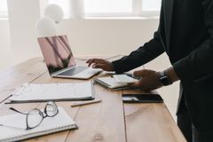 Professional workspace with a laptop, documents, and stationery on a wooden table.