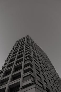 Low angle shot of a high-rise building in Zurich, Switzerland, in black and white.