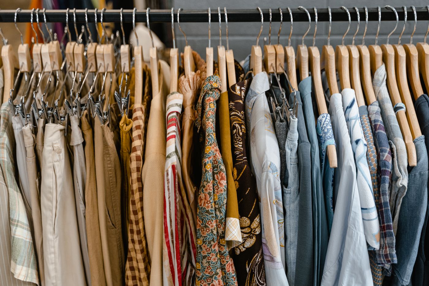Assorted new-season apparel on hangers on a black steel clothing rack