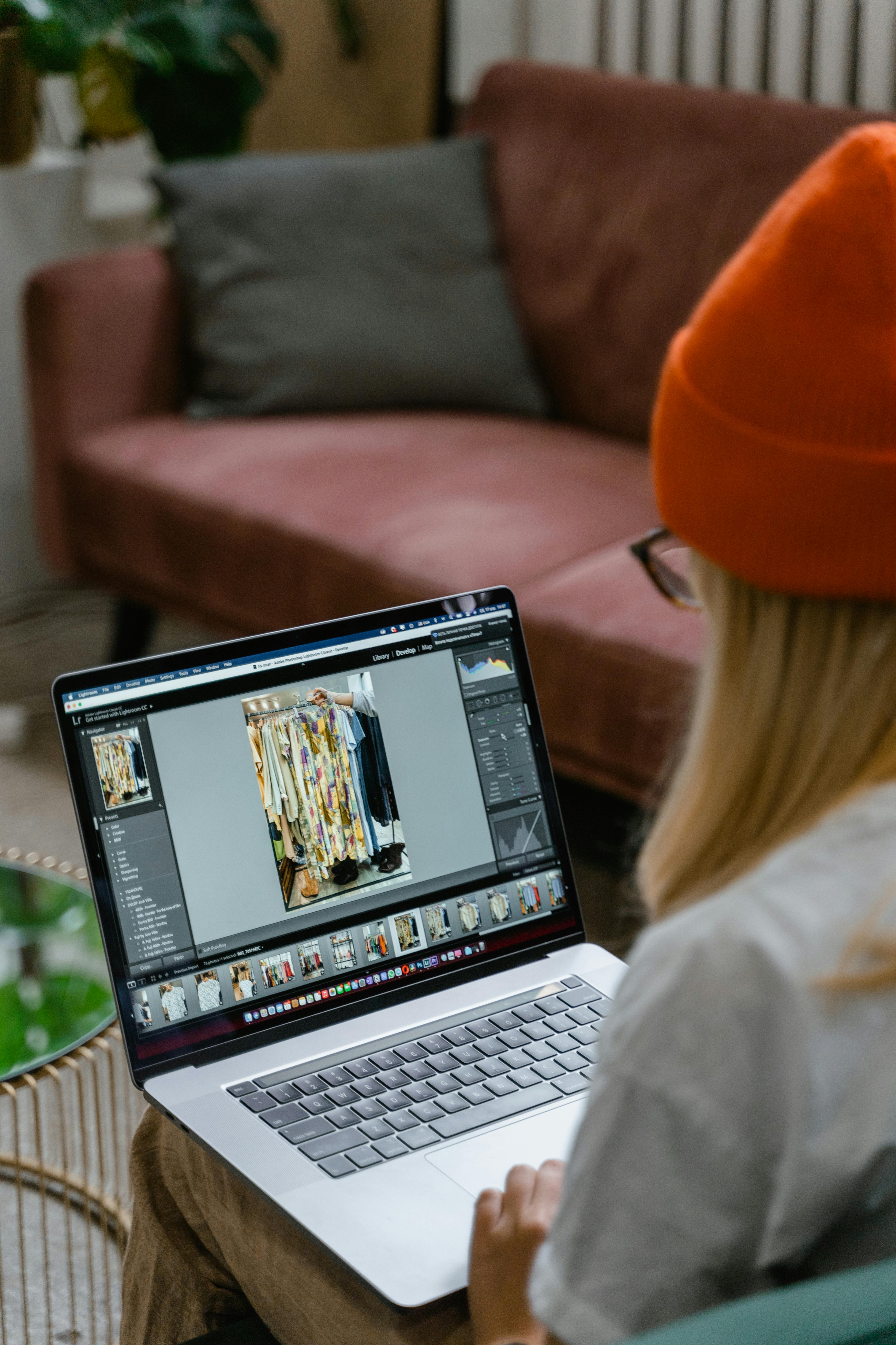 woman in red knit cap using a laptop