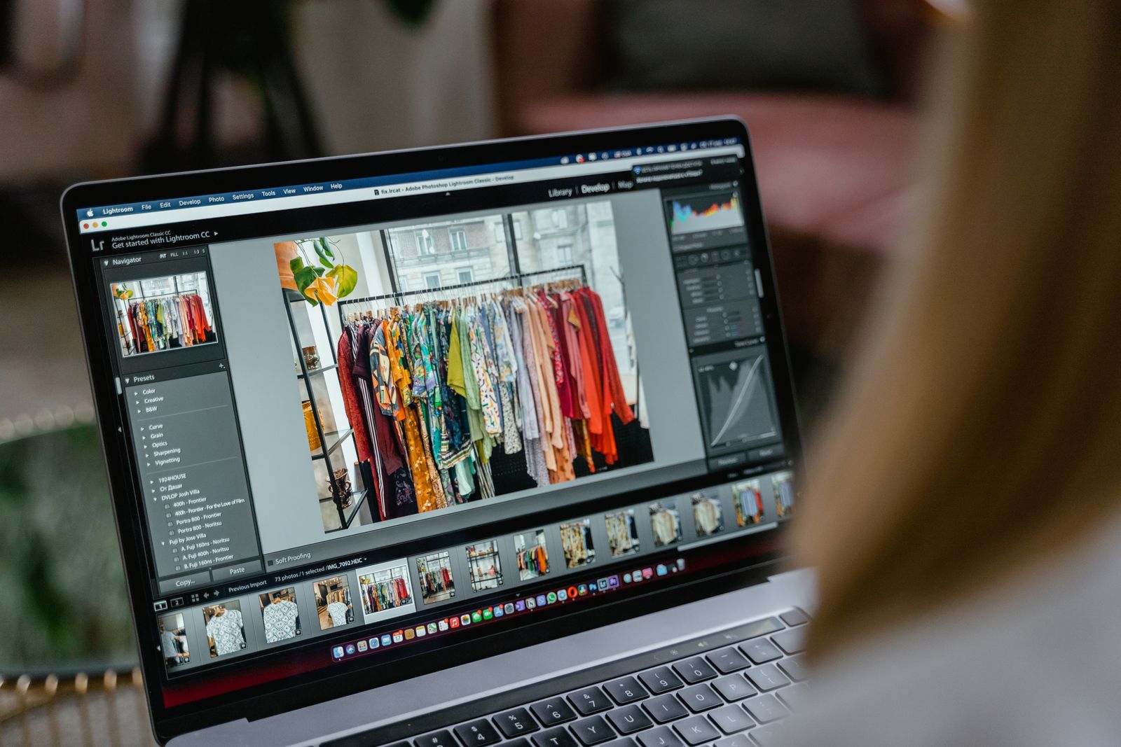 A photographer editing images on a laptop, where IPTC and XMP fields are typically added.