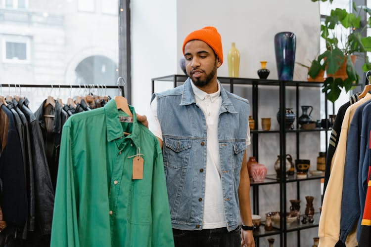 A Man Holding A Green Long Sleeves Polo 