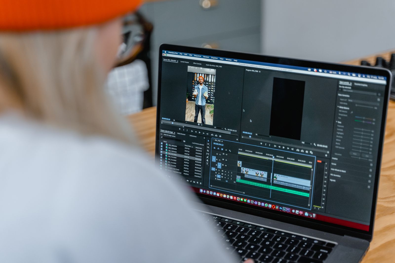 A close-up of an editing timeline on a laptop screen showing clips and audio tracks