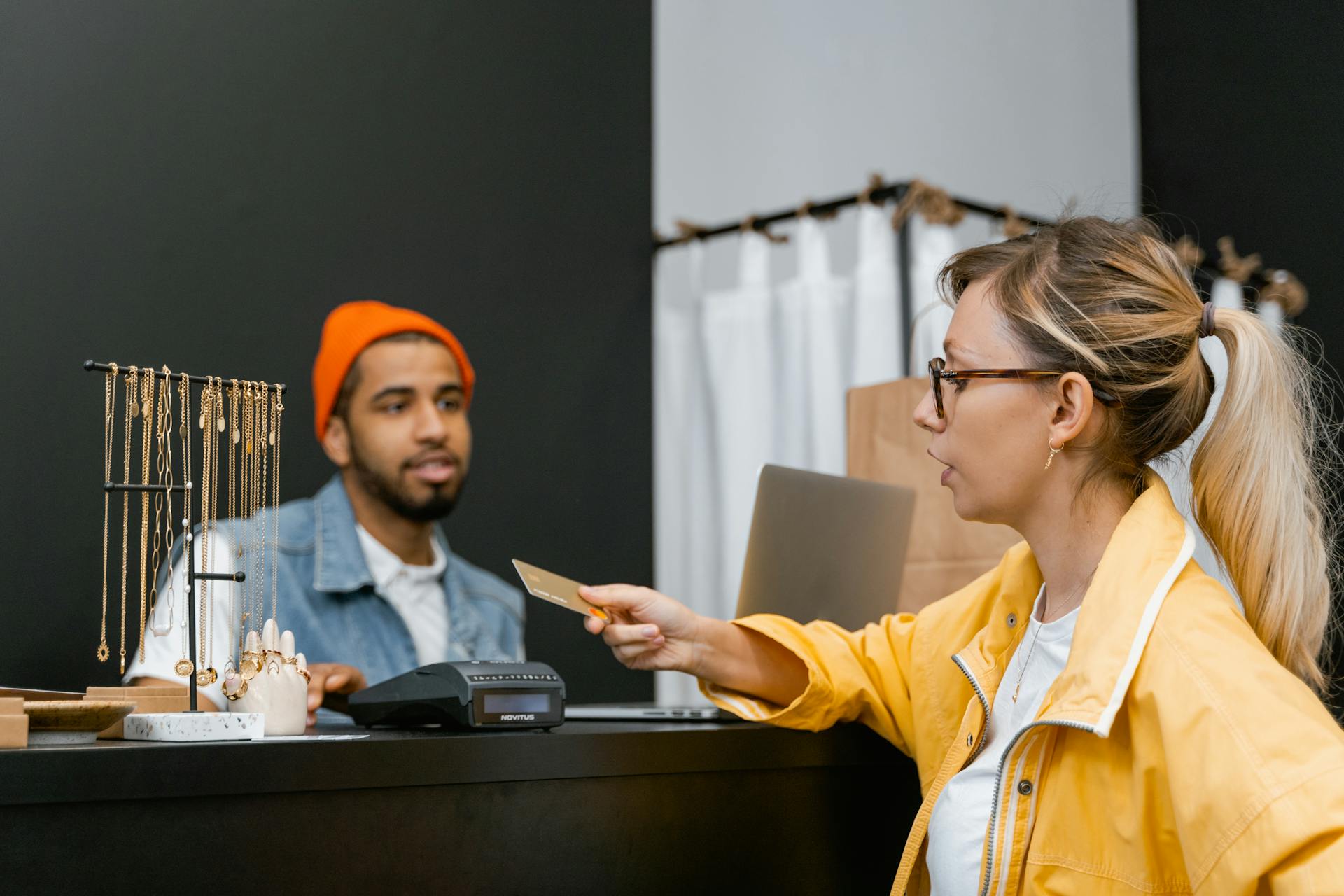 A Woman  Using a Credit Card in a Store