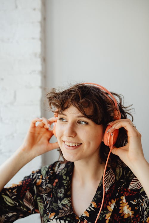 Free Smiling Woman Listening to Music Stock Photo