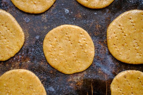 Free Close-up view of freshly baked cookies on a rustic baking tray, highlighting texture and color. Stock Photo