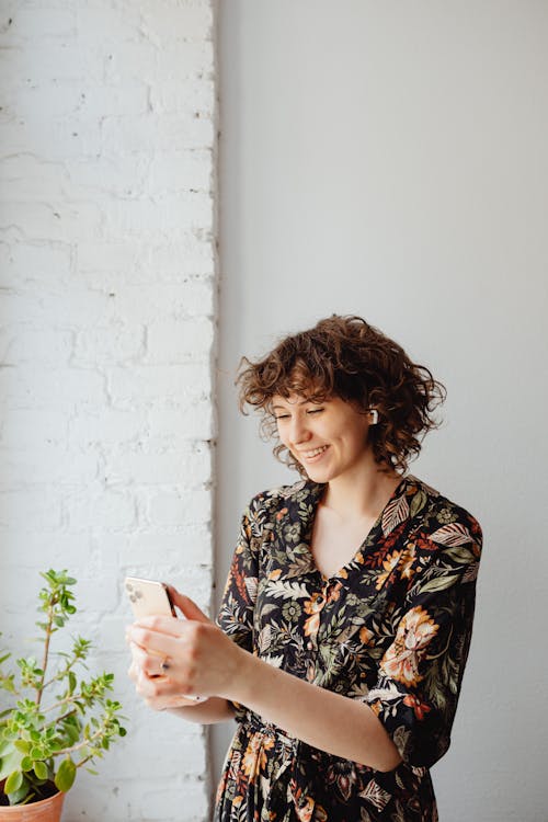 A Woman in Floral Dress Using a Cellphone