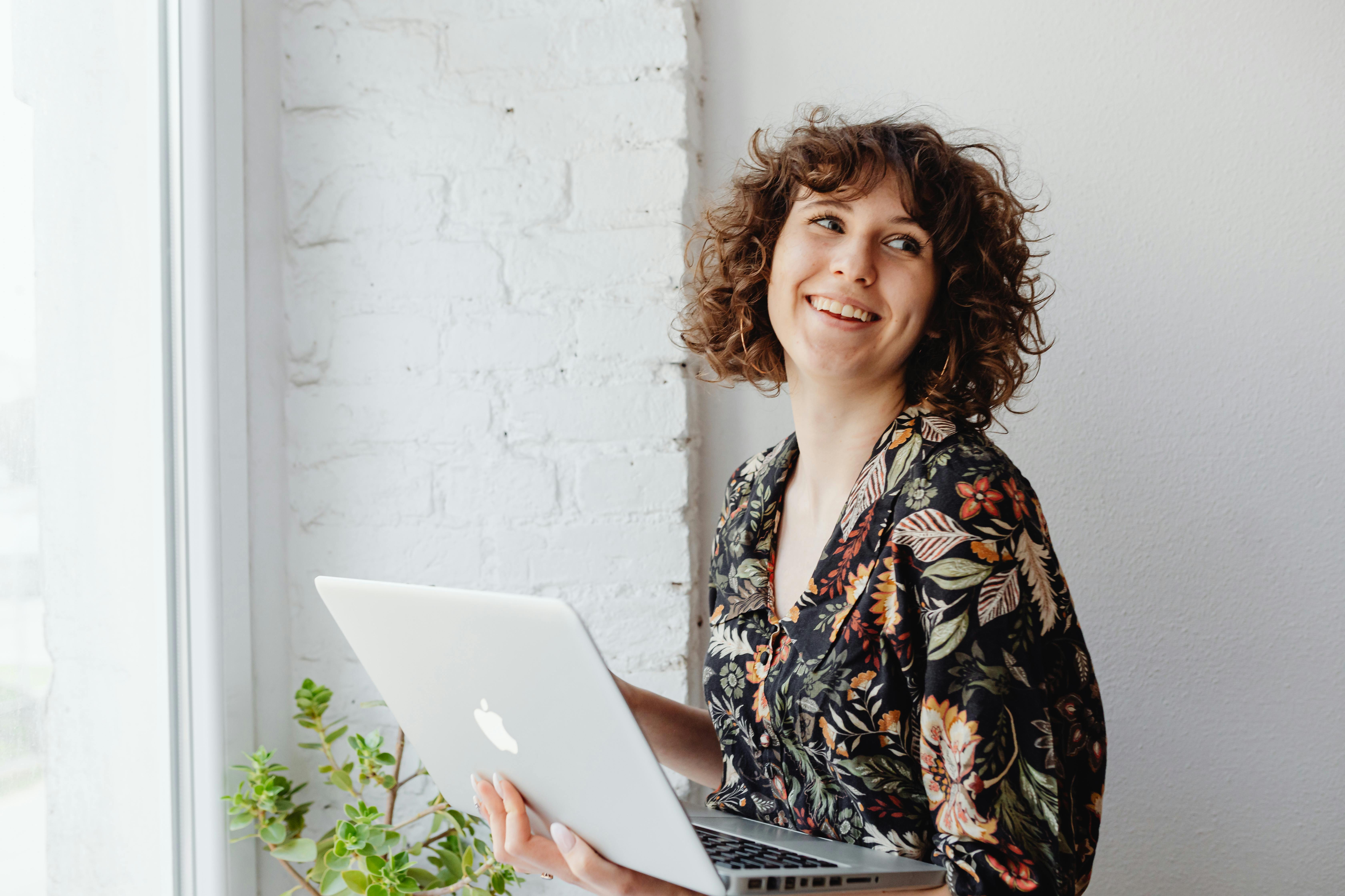 Beautiful Woman Carrying a Laptop while Looking Away