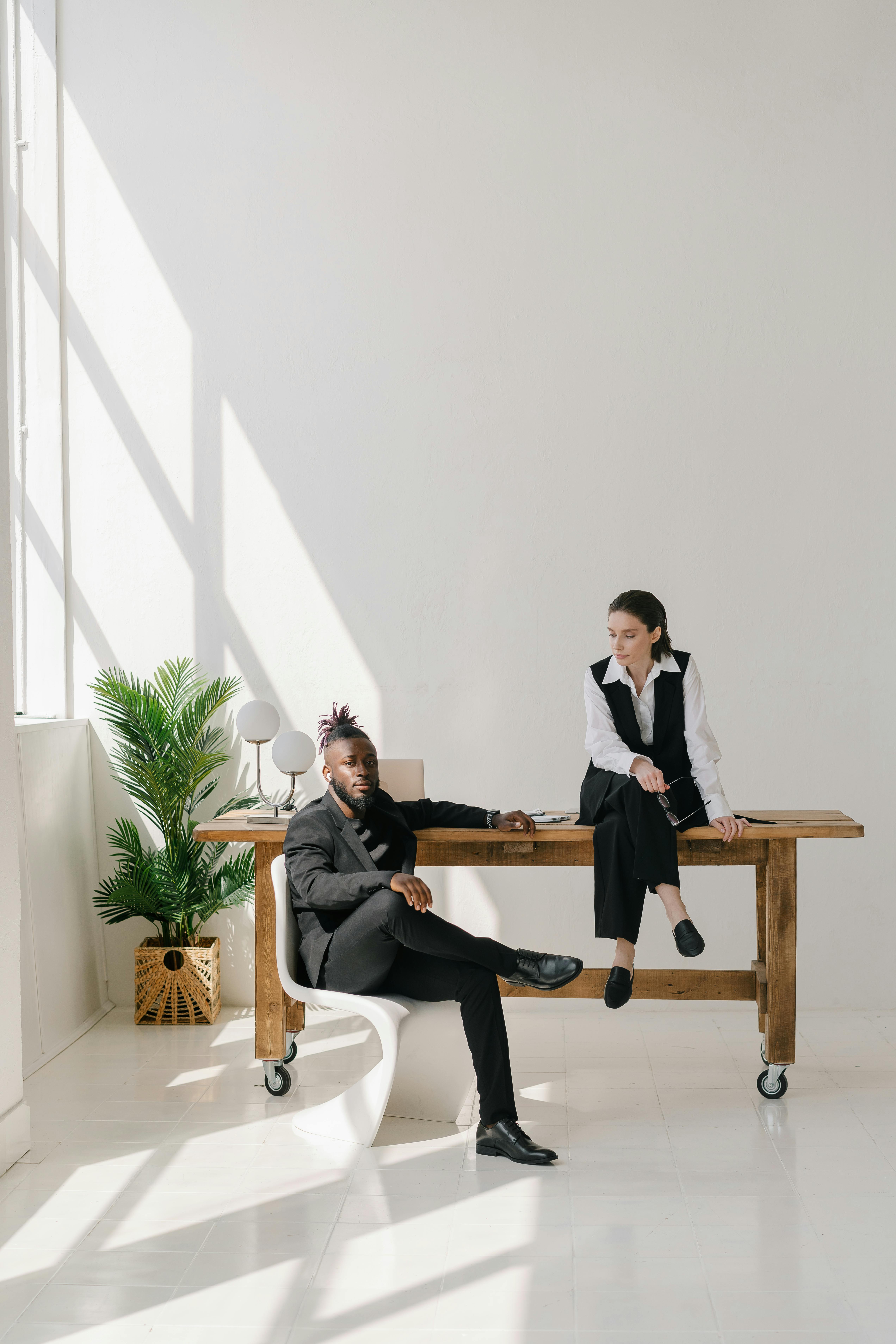 a man and a woman sitting cozily inside the office