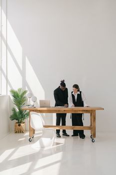 Man and Woman Standing by the Wooden Table