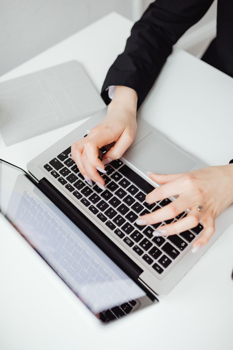 Hands typing on a laptop at a clean desk — photo by www.kaboompics.com on Pexels
