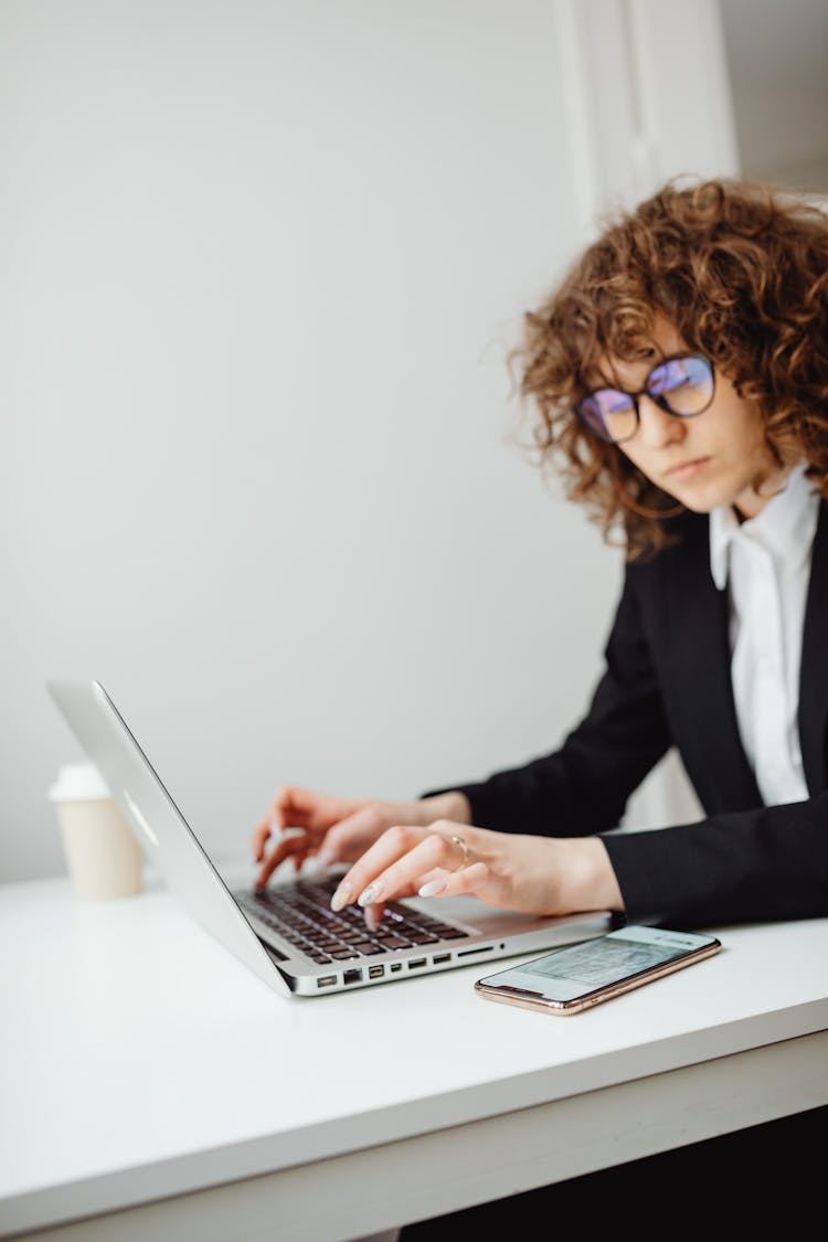 Woman Wearing Eyeglasses While Using Her Laptop