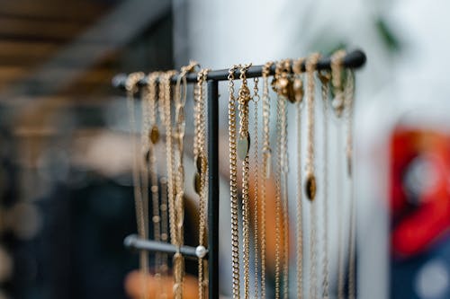 Gold Necklaces Hanging on Jewelry Stand 