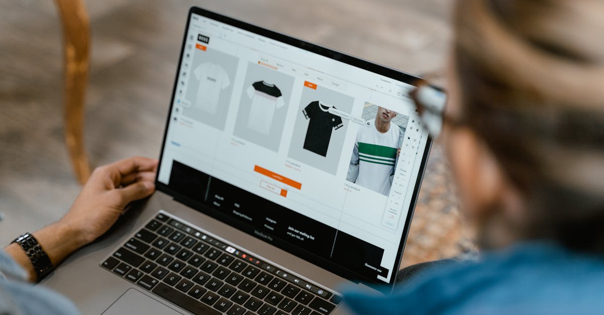 Two people collaborating on a laptop for t-shirt design and selection.