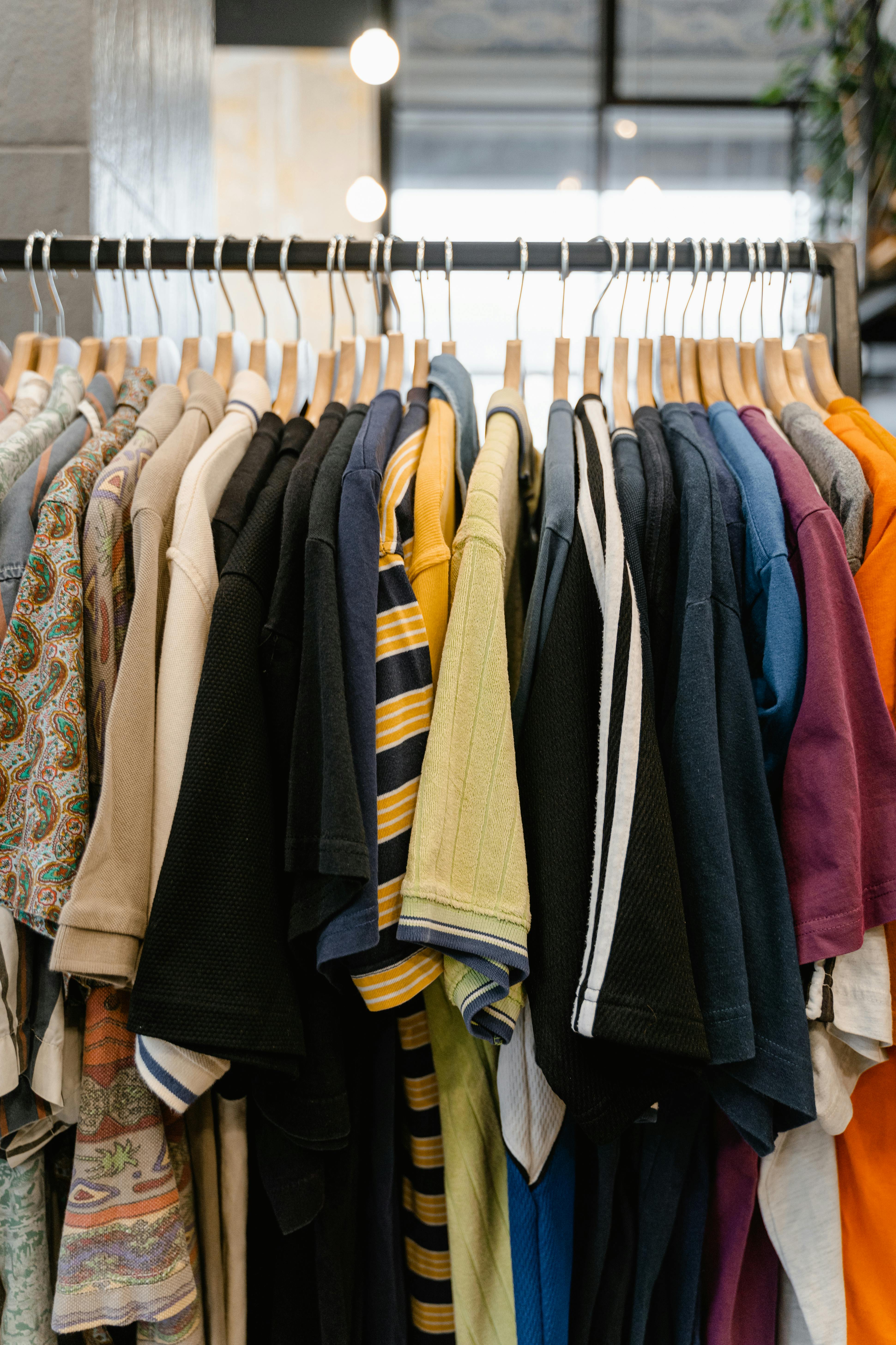 assorted clothes hanged on rack