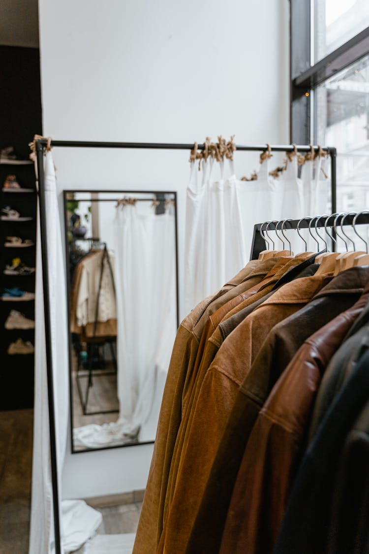 Brown Jackets Hanging On Black Steel Rack