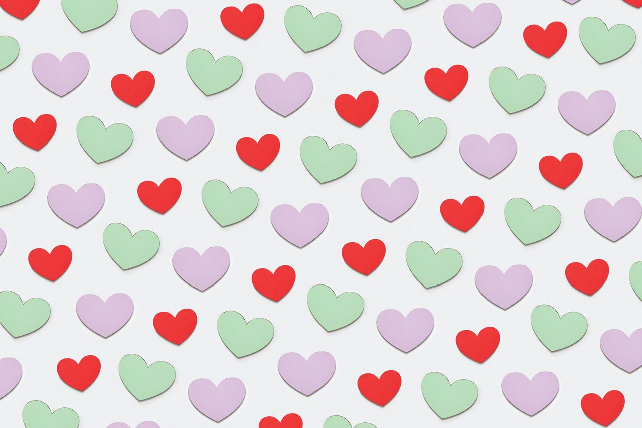 a delightful pattern of colorful paper heart cutouts in red green and