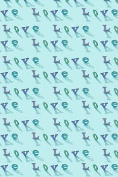 Creative typography pattern with the word 'love' on a light blue background. Ideal for wallpapers and design projects.