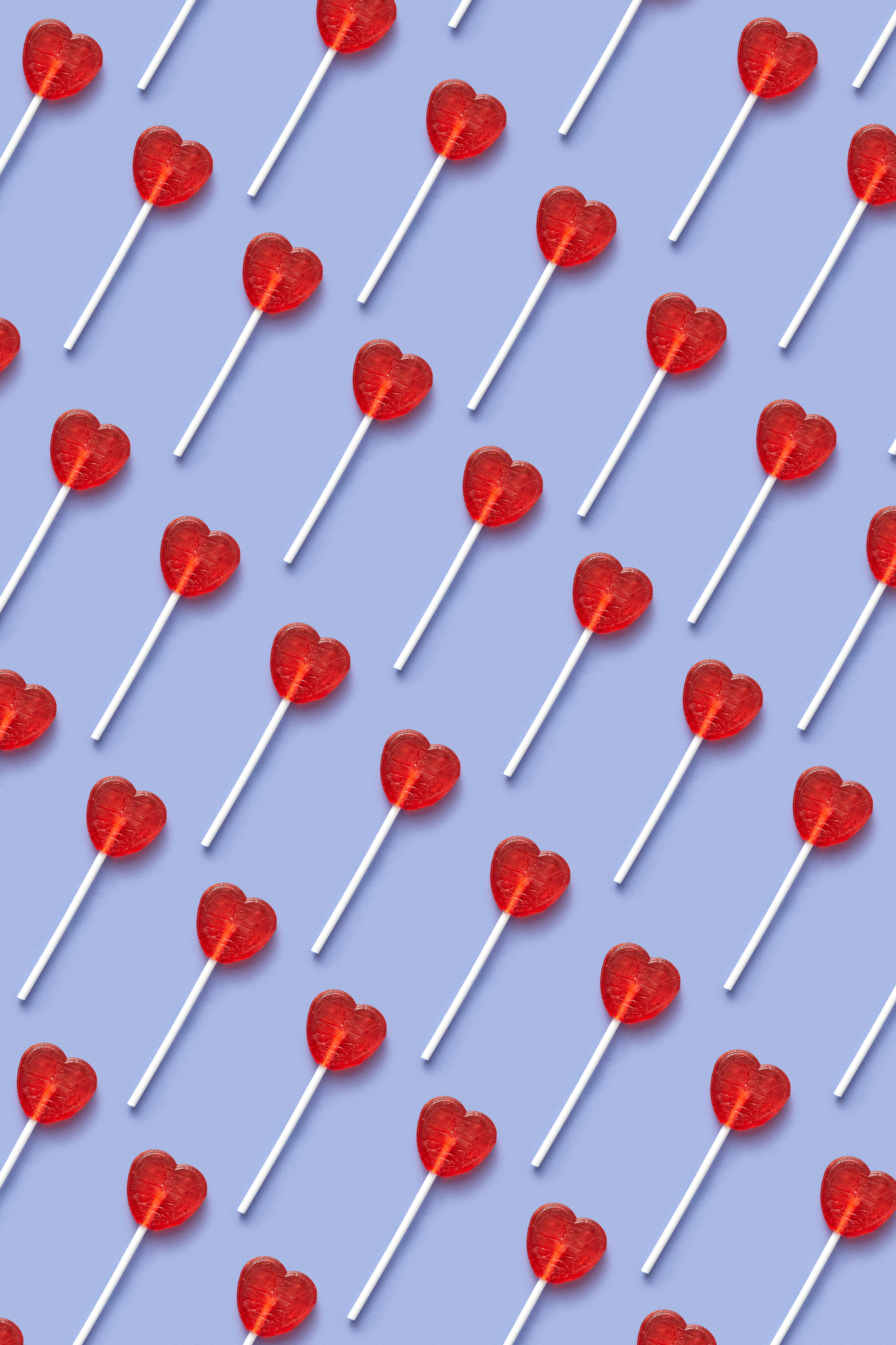 Heart Shaped Lollipop on Blue Background · Free Stock Photo