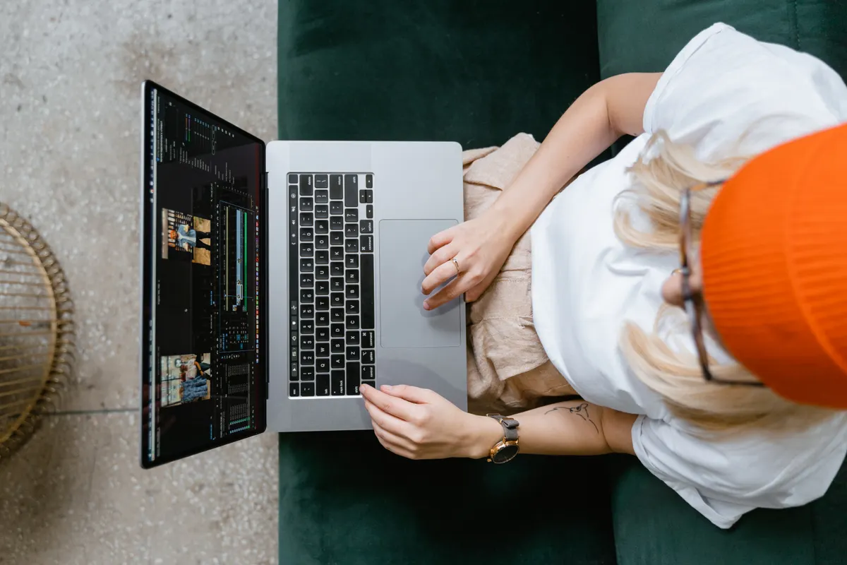 Marketer using AI writing software on a laptop to streamline their digital marketing assistant tasks.