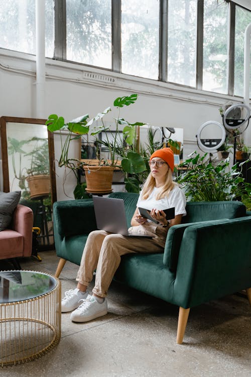 Woman Sitting on Green Couch