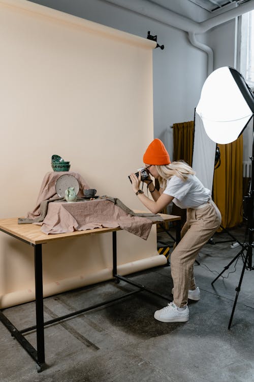 A Woman Taking Photos of the Silverware on the Table