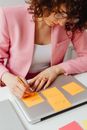 Woman in Pink Long Sleeve Shirt Holding White Paper
