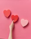 A Person Finger Pressing the Heart Shaped Sponge
