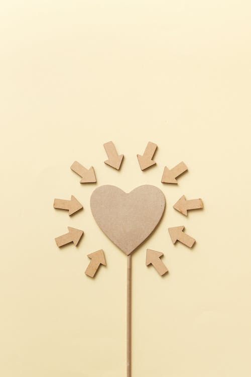 Cutout Heart Surrounded by Pointing Arrows 