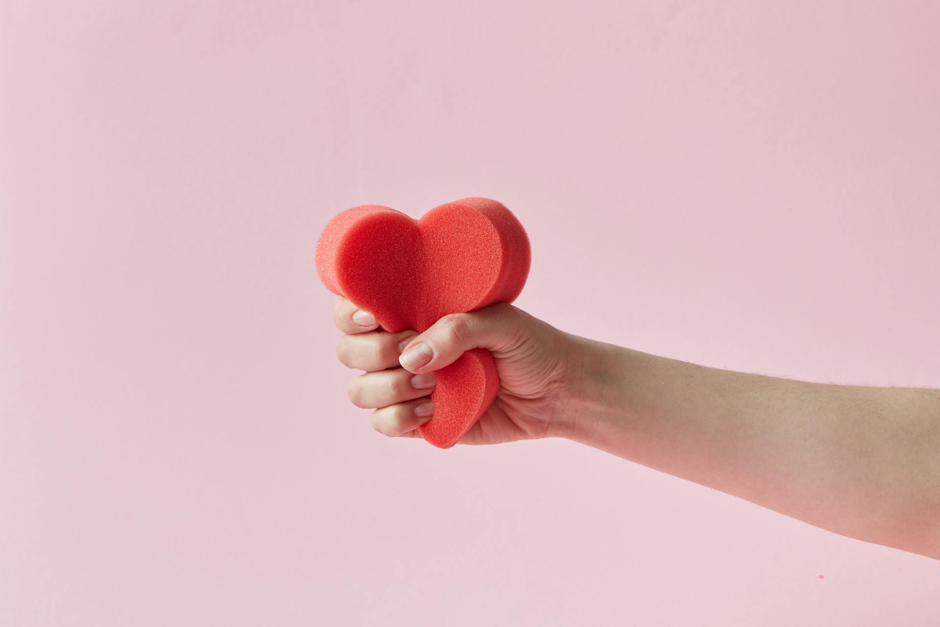A Person Holding a Foam Heart Cutout
