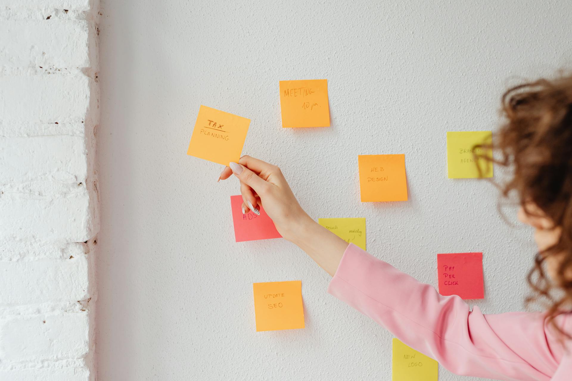 Person Holding a Sticky Note