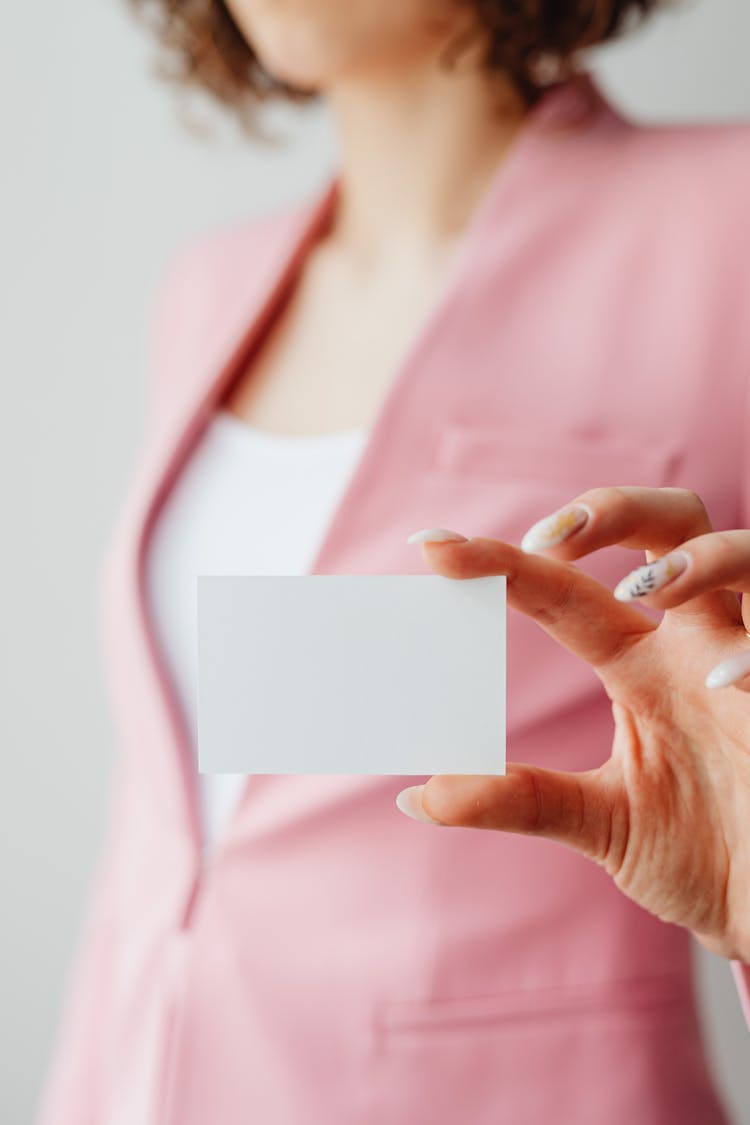 Woman In Pink Blazer Holding A Blank Card