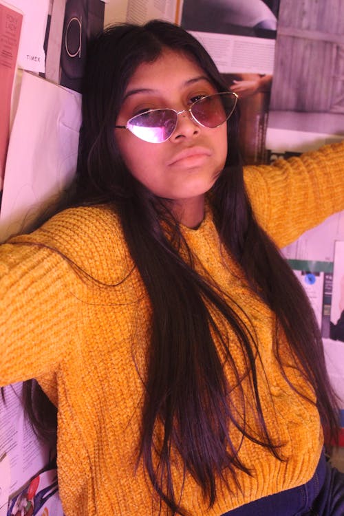 Woman in Yellow Knit Sweater Wearing Triangular Framed Sunglasses