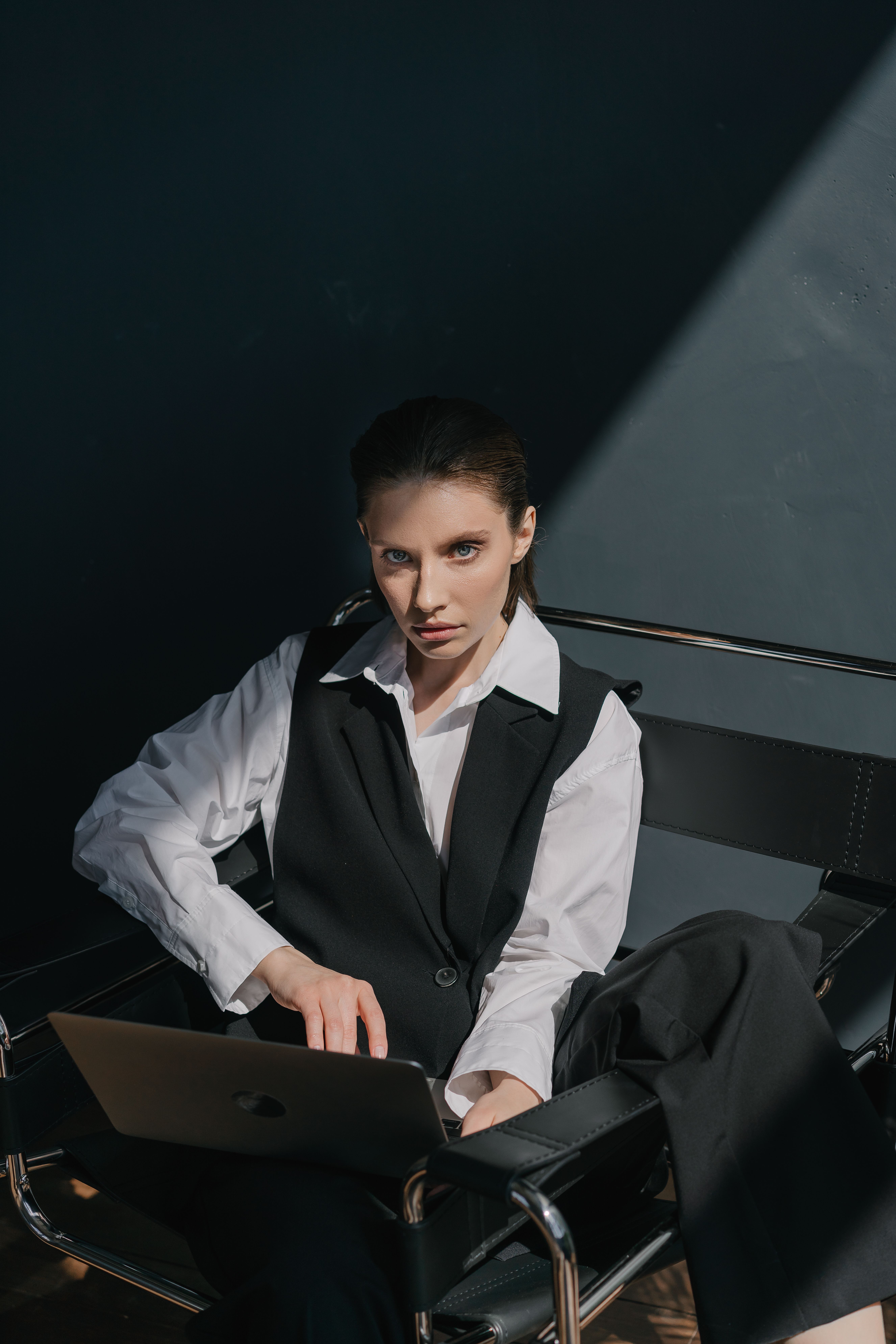 Woman in tailored vest layering office casual outfit