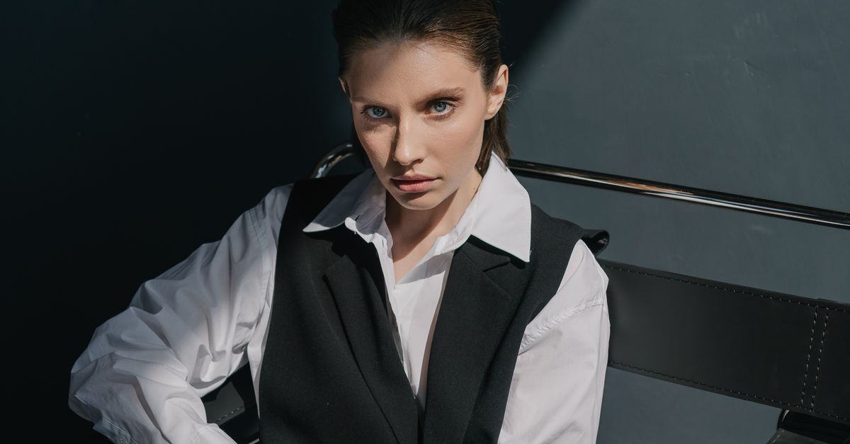 Woman in tailored vest layering office casual outfit