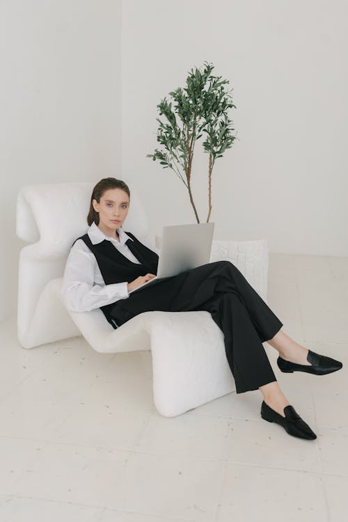 Free Man in Black Suit Sitting on White Sofa Chair Stock Photo
