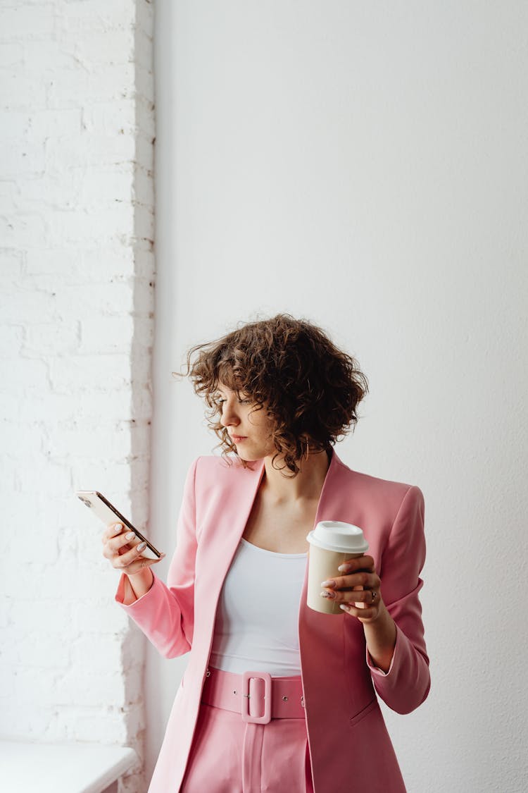 Woman In Pink Suit Using A Cellphone