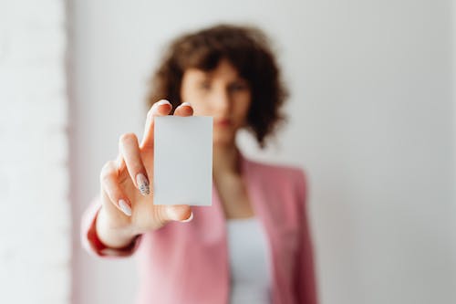 Selective Focus of a Person Holding an Empty Business Card