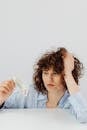 Woman in White Button Up Shirt Holding White Printer Paper