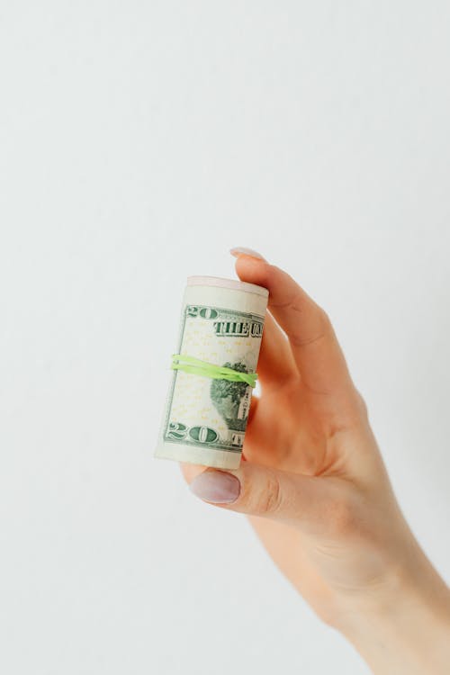 Free Person Holding a Rolled Cash Stock Photo